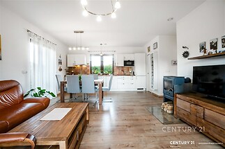 Prostorný obývací pokoj s moderní kuchyní, parketová podlaha, krbová kamna, světlý interiér s velkými okny a dřevěným nábytkem