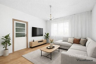 Světlý obývací pokoj s moderní sedací soupravou, parketová podlaha, velká okna poskytující přirozené světlo, vkusné zařízení interiéru.