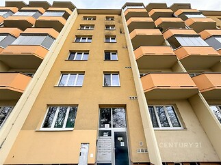 Panelový bytový dům s balkonem, zateplená fasáda, plastová okna, rekonstruovaný vchod, vhodný pro rodinné bydlení.