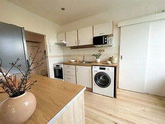 kuchyně s mikrovlnná trouba, dřevěná podlaha, backsplash, a pračka / sušička