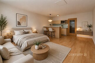 Prostorná ložnice s parketovou podlahou, moderní kuchyňský kout, světlý interiér, minimalistické zařízení, dřevěný nábytek.