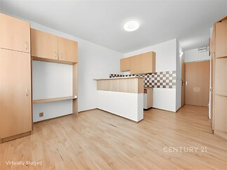 Moderní kuchyň s parketovou podlahou a vestavěnými skříněmi, světlý prostor s elegantními dřevěnými prvky a praktickým uspořádáním.