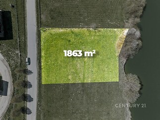 Dostupný stavební pozemek o rozloze 1863 m², ideální pro developerský projekt, situovaný blízko vody, s příjezdem po asfaltové cestě.