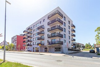 Moderní bytový dům s velkými balkony, kvalitní fasádou a moderním designem se nachází v blízkosti centra města.