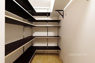 Spíž s otevřenými policemi, tmavé dřevo, světlé stěny, moderní design, praktické úložné prostory.