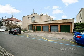 Rodinný dům s moderní fasádou a trojgaráží v klidné lokalitě, kvalitní zdivo, rovná střecha, ideální pro rodinu hledající komfortní bydlení