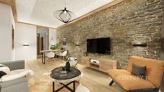 Světlý obývací pokoj s parketovou podlahou, kamennou zdí a moderním osvětlením, nabízí útulnou atmosféru a stylové zařízení.