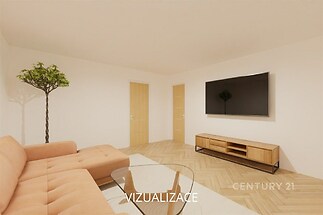 Světlý obývací pokoj s parketovou podlahou, moderní sedací soupravou a velkou obrazovkou. Stylová dřevěná komoda dodává prostoru eleganci.