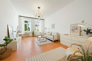 Světlý obývací pokoj s parketovou podlahou, velkými okny a moderním nábytkem. Elegantní osvětlení dodává místnosti příjemnou atmosféru.