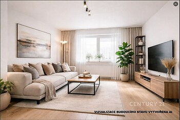 Světlý obývací pokoj s parketovou podlahou, moderní nábytkem a velkými okny, které zajišťují dostatek přirozeného světla.