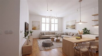Světlý obývací pokoj s parketovou podlahou, velká okna, moderní dřevěný nábytek, stylové dekorace, útulný a elegantní design.