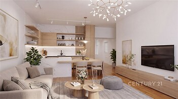 Moderní obývací pokoj s parketovou podlahou, vestavěnými skříněmi a světlým dekorativním osvětlením, propojený s elegantní kuchyní.