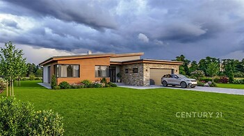 Moderní rodinný dům s dřevěnou fasádou, velkými okny a garáží. Prostorný pozemek a upravená zahrada poskytují klidné bydlení.