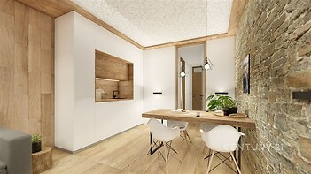 Moderní kuchyň s dřevěnou podlahou a obložením, kamenná zeď, vestavěné spotřebiče a minimalistický jídelní kout se stylovým nábytkem.