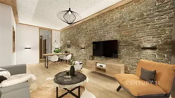 Světlý obývací pokoj s parketovou podlahou, kamennou zdí a moderním osvětlením, nabízí útulnou atmosféru a stylové zařízení.
