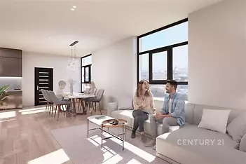 Světlý obývací pokoj s parketovou podlahou, velkými okny a moderním stylem, propojený s jídelním koutem, nabízí prostor pro společné chvíle.